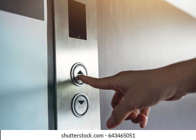 Hand Press A Button Of Elevator Inside The Building For Upper High Level Floor, Close Up Shot And Focus On Button