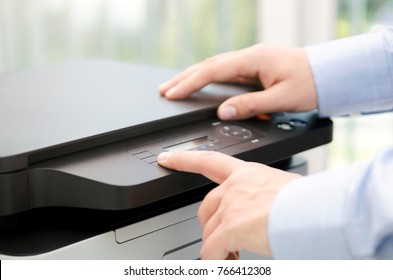 Hand press button on panel of printer. printer scanner laser office copy machine supplies start concept