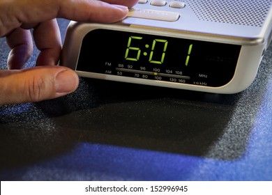 Hand Press The Stop Button Of The Digital Alarm Clock.