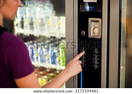 Hand presses button of vending machine pannel. Self-used technology and consumption concept