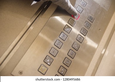 Hand presses the elevator button of the eleventh floor