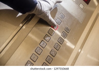 Hand presses the elevator button of the eleventh floor