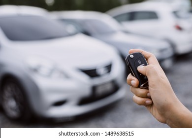 Hand presses on the remote control car alarm systems. - Shutterstock ID 1489638515