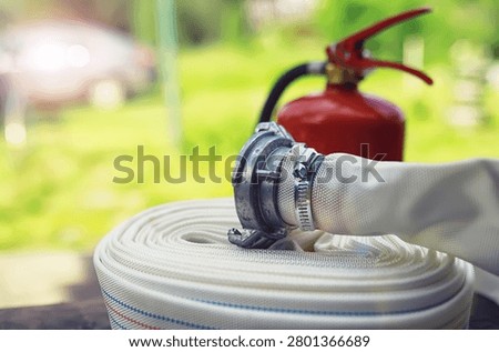 hand presses the trigger fire extinguisher available in fire emergencies conflagration damage background. 