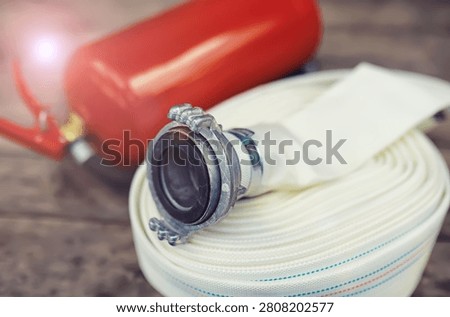hand presses the trigger fire extinguisher available in fire emergencies conflagration damage background. 