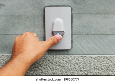 Hand Pressing Doorbell