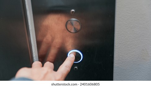 hand pressing elevator button, symbolizing choice and progress