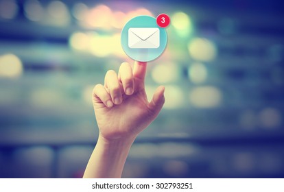 Hand pressing an email icon on blurred cityscape background  - Shutterstock ID 302793251
