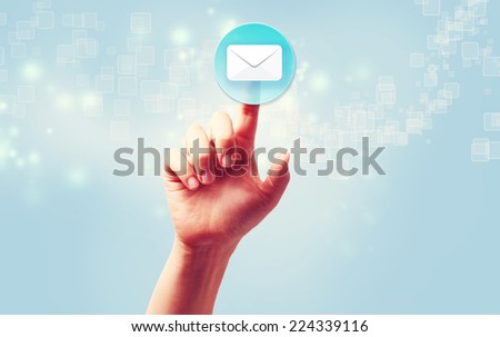 Hand pressing a envelope icon over light blue background