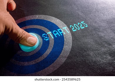 A hand pressing a glowing button with the text "START 2025" on a futuristic interface, symbolizing the beginning of the new year 2025 - Powered by Shutterstock