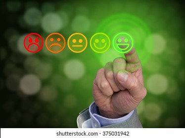 Hand pressing green smiley button of performance rating on dark background with bokeh