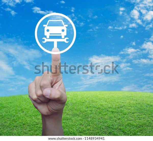 Hand
pressing service fix car with wrench tool icon over green grass
field with blue sky, Business repair car
concept