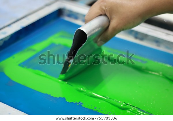Hand\
pressing silk-screen printing, close up\
view.