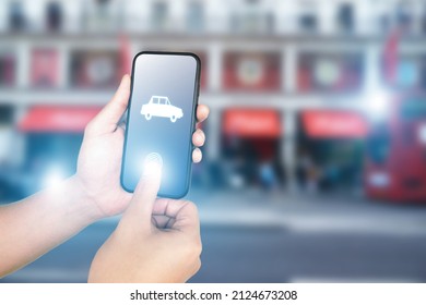 hand pressing smartphone for calling taxi, transportation and technology concept, city as background, 