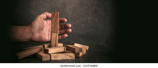 Hand Prevent Wooden Block Tower Stack Not Falling. Concept Of Prevention Of Financial Business And Risk Management Or Strategic Planning.