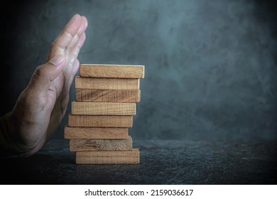 Hand Prevent Wooden Block Tower Stack Not Falling. Concept Of Prevention Of Financial Business And Risk Management Or Strategic Planning.