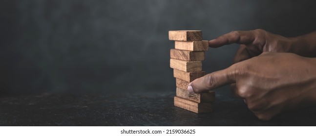 Hand Prevent Wooden Block Tower Stack Not Falling. Concept Of Prevention Of Financial Business And Risk Management Or Strategic Planning.