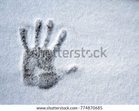 A hand print on fresh snow. Virtual greeting.