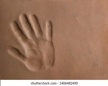Hand print silhouette in clay soil.  Hand print pattern in natural clay background.
