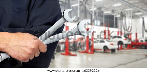Hand of
professional Auto mechanic with
wrench.