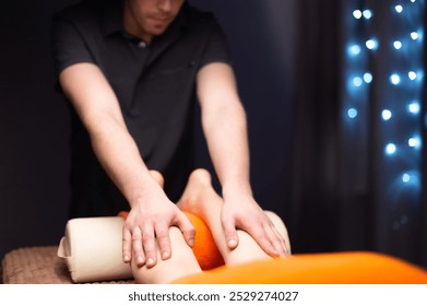 Hand of professional massage therapist, foot massage with oil, preparing client's feet for massage in health spa center. Foot massage concept - Powered by Shutterstock