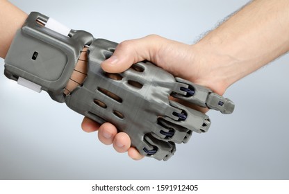 Hand with prosthesis printed on FDM 3D printer, handshake of the prosthesis and a healthy hand on an isolated background.