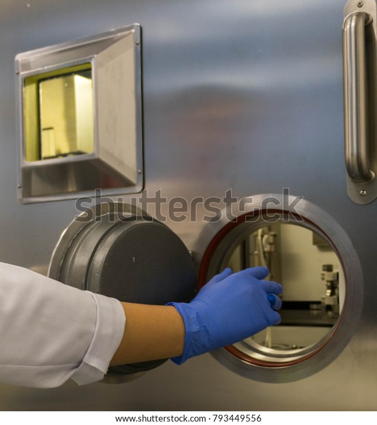 hand in a protective glove with a lead\
syringe - work in a nuclear medicine\
center