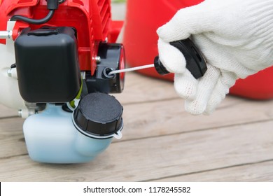 Hand In A Protective Glove, Pulls The Cord To Start The Gasoline Engine Mower