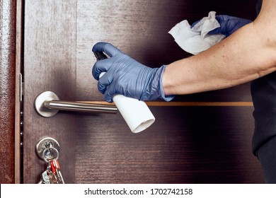 Hand in protective glove with rag cleaning door handle. Covid-19 disinfection concept - Shutterstock ID 1702742158