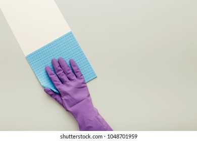 Hand In Protective Rubber Glove With Blue Rag. Woman Washing White Surface With Micro Fiber Cloth, Before And After Effect. Cleaning Services And Tidying Up Concept, Copy Space