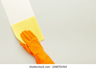 Hand In Protective Rubber Glove With Yellow Rag. Woman Washing White Surface With Micro Fiber Cloth, Before And After Effect. Cleaning Services And Tidying Up Concept, Copy Space