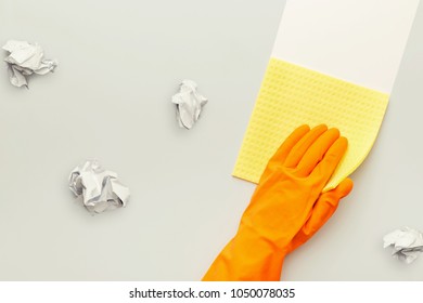 Hand In Protective Rubber Glove With Yellow Rag And Crumpled Papers. Woman Washing White Surface With Micro Fiber Cloth, Before And After Effect. Cleaning Services And Tidying Up Concept, Copy Space