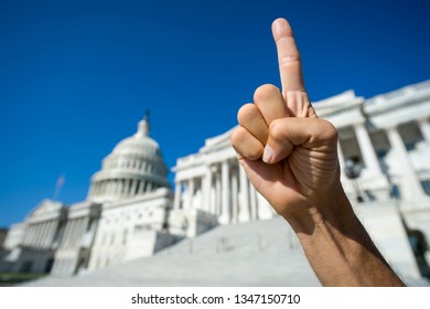 Hand of a proud America First protestor gesturing with a single index finger pointing skyward in front of the Capitol Building in Washington, DC, USA