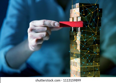 hand pull important color block from balance wooden stack business strategy and risk management control concept - Shutterstock ID 1113159899