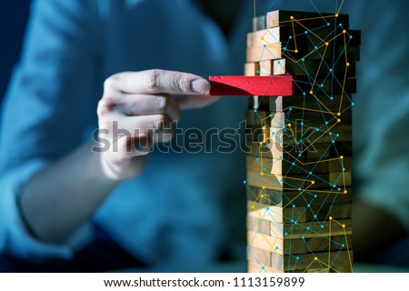 hand pull important color block from balance wooden stack business strategy and risk management control concept
