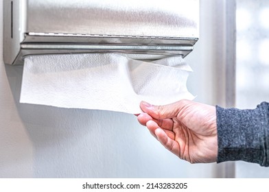 Hand Pull White Paper Towel From Tissue Box That Mounted In The Public Bathroom. Hygiene People, A Man Take Disposable Clean Sheet To Cleaning Hand.