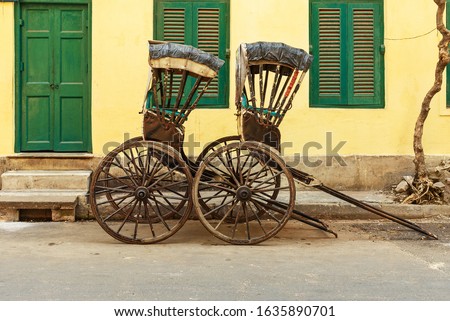 Hand pulled rickshaws are parkedon the street in Kolkata. India