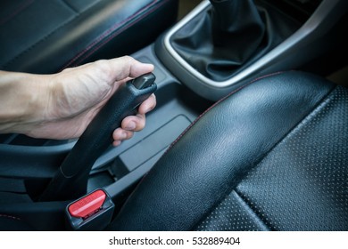 Hand Pulling The Hand Brake In Car - Car Interior, Focus On Hand Break