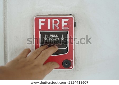 A hand was pulling down the fire call to fire alarm.