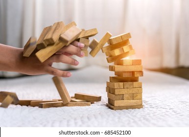 Hand Of Pulling Out Wood Block Fail On Building Tower At Home And Drape Change, Choice Business Risking Dangerous Project Plan Failure Construction Concept.