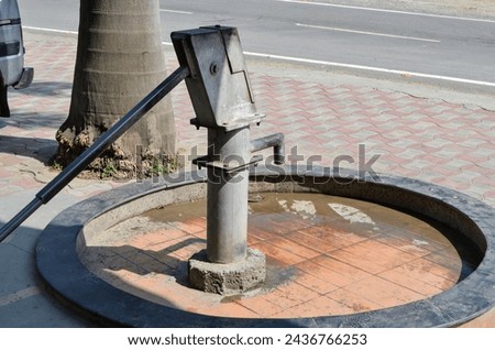 Hand pump, hand-operated water pump in a rural area of Himachal Pradesh, India. Hand pump are the main source of safe and clean water. They can draw clean ground water. Installed on boreholes. 商業照片 © 