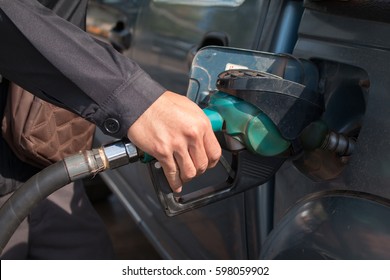 Hand Pumping Gas Into Car.