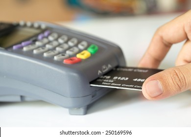 Hand Push Credit Card Into A Credit Card Machine : Selective Focus