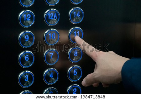 Hand push the elevator button 11th floor