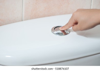 hand push the flush button - Shutterstock ID 518876107