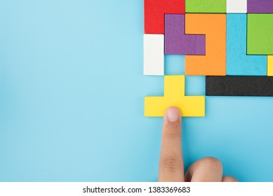 Hand push last piece jigsawto finish success planning concept solve puzzle isolated on blue background top view , logical thinking - Shutterstock ID 1383369683