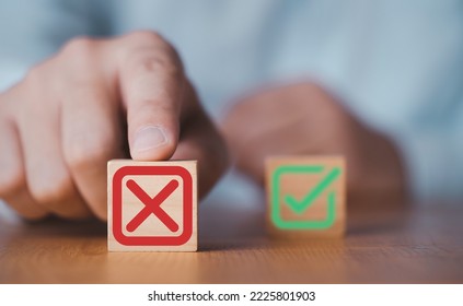 Hand push red Red Cross mark to choose cancellation item , Approve and reject business and document concept. - Shutterstock ID 2225801903