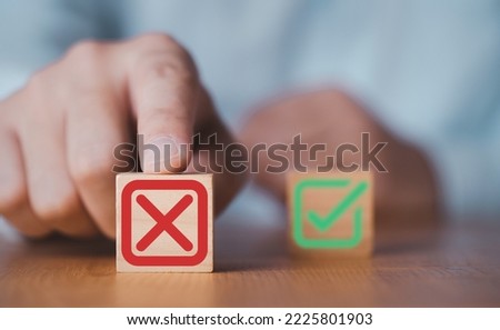 Hand push red Red Cross mark to choose cancellation item , Approve and reject business and document concept.