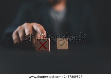 Hand push red Red Cross mark to choose cancellation item , Approve and reject business and document concept.