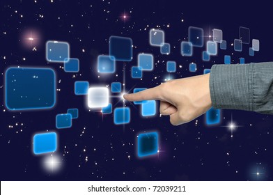 hand pushing a button on a touch screen interface under starry night sky